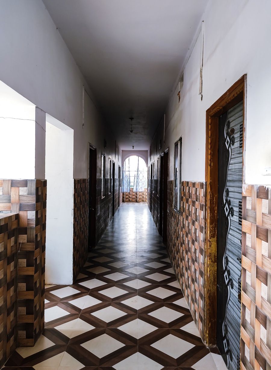 Tiled corridor leading to guest rooms at Hotel Vijay, Rajgir